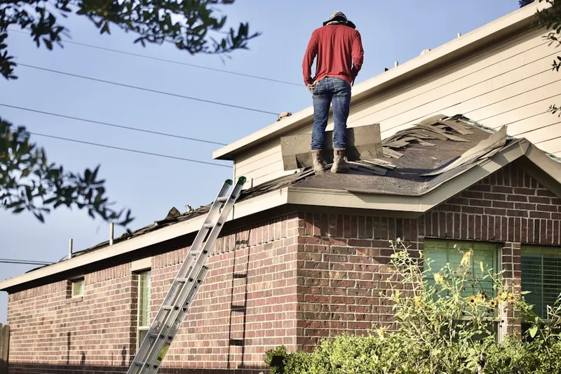 Professional roofer working on a residential roof in Granger North